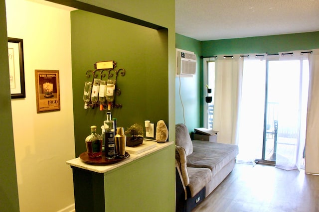 interior space featuring a textured ceiling and a wall unit AC