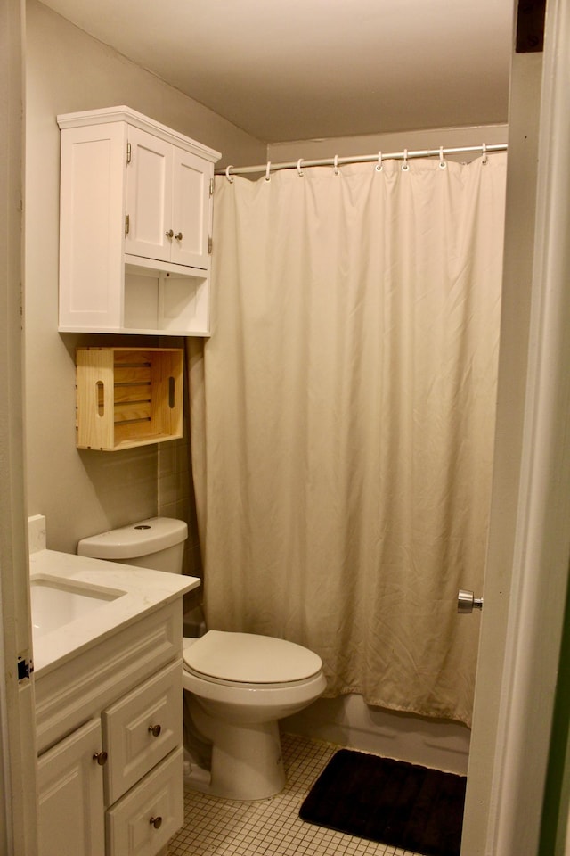 bathroom with tile patterned floors, vanity, curtained shower, and toilet