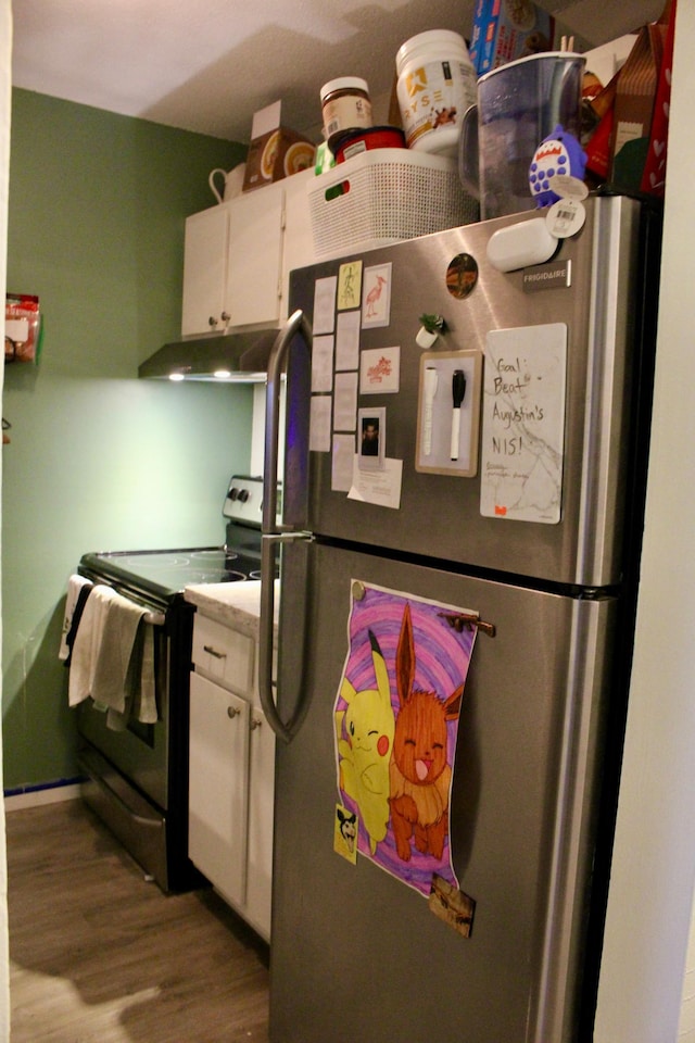 kitchen with stainless steel fridge, white cabinetry, black electric range, and light hardwood / wood-style floors