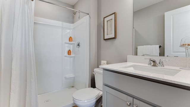 bathroom with toilet, vanity, and a shower with shower curtain