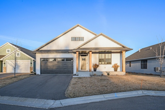 371 Liberty Dr, Hanover, MN 55341 - modern farmhouse with central AC unit, an attached garage, covered porch, and driveway