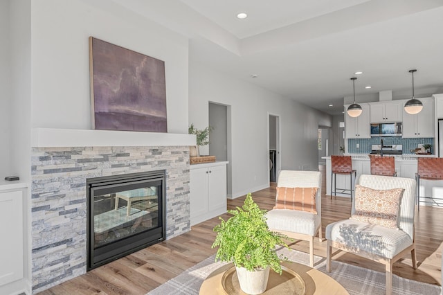 living room featuring light hardwood / wood-style flooring and a fireplace