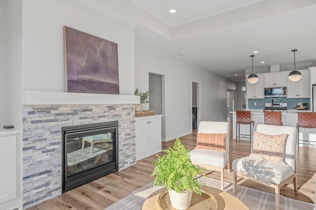 371 Liberty Dr, Hanover, MN 55341 - living room with light wood finished floors, a stone fireplace, and recessed lighting