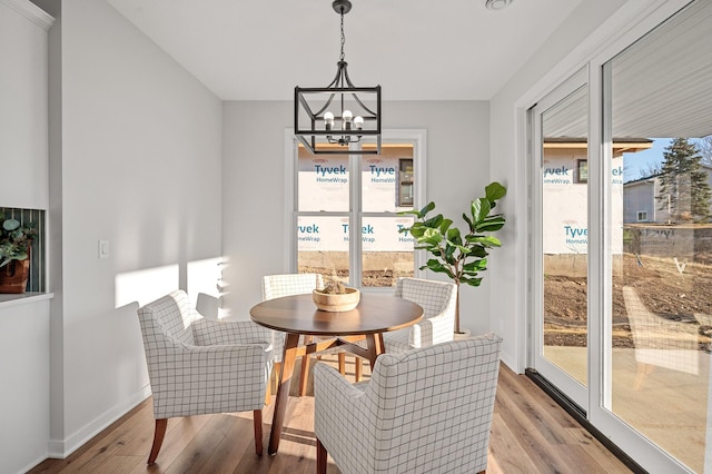 dining room featuring a notable chandelier and light wood-type flooring