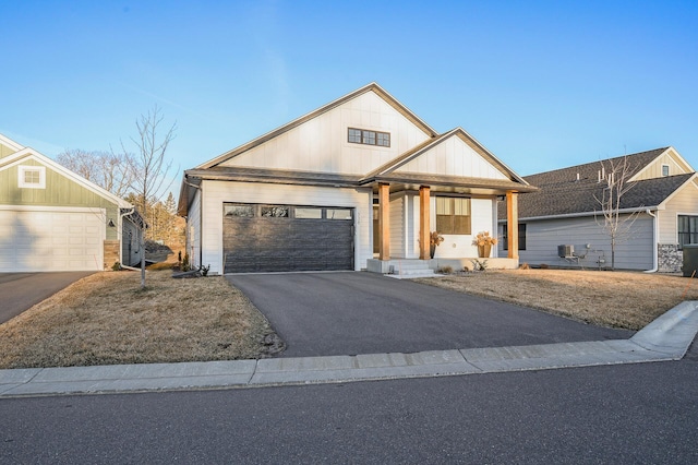 371 Liberty Dr, Hanover, MN 55341 - view of front of home featuring covered porch, board and batten siding, driveway, and an attached garage
