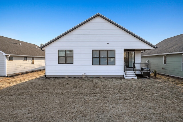 back of house with a lawn