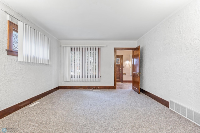 carpeted spare room with ornamental molding