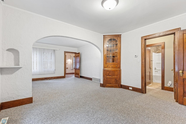 carpeted empty room featuring ornamental molding