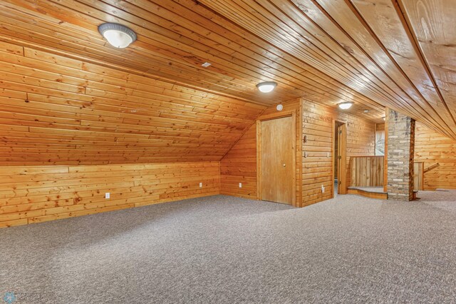 bonus room featuring carpet flooring, wood walls, wooden ceiling, and vaulted ceiling