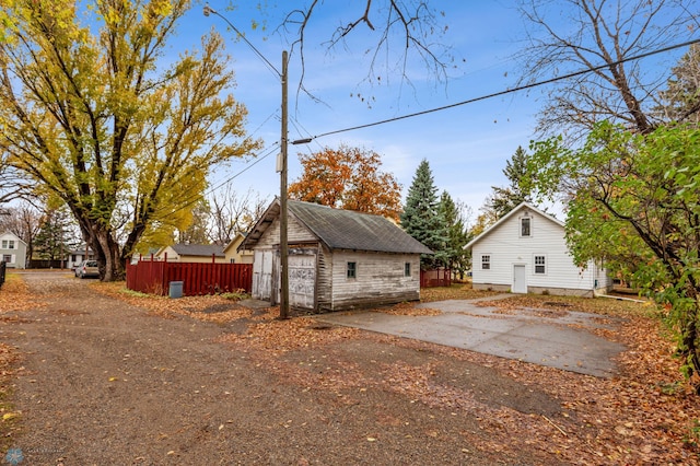 view of side of home with a garage and an outdoor structure