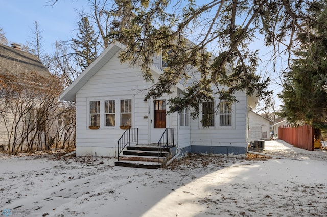 bungalow-style house featuring central AC unit