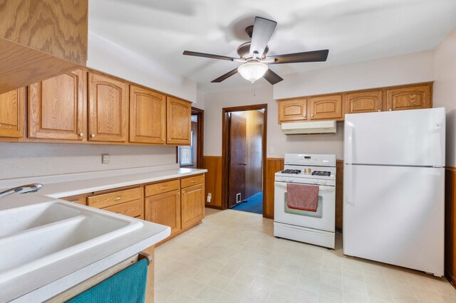 kitchen featuring ceiling fan, sink, and white appliances