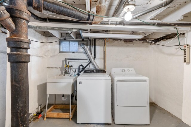 laundry area with washing machine and dryer and sink