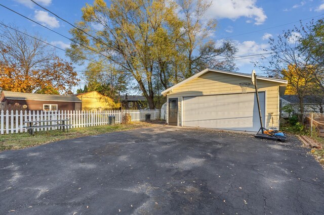 view of home's exterior with a garage and an outdoor structure