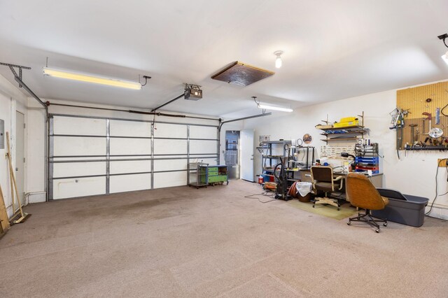 garage with a workshop area and a garage door opener