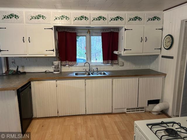 kitchen with sink, light wood-type flooring, dishwasher, backsplash, and white cabinetry