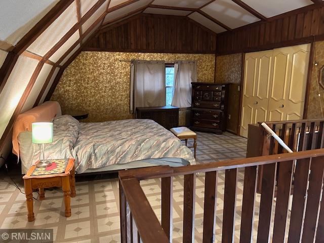 bedroom with lofted ceiling and a closet