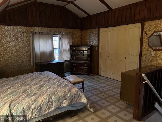 bedroom featuring lofted ceiling and a closet