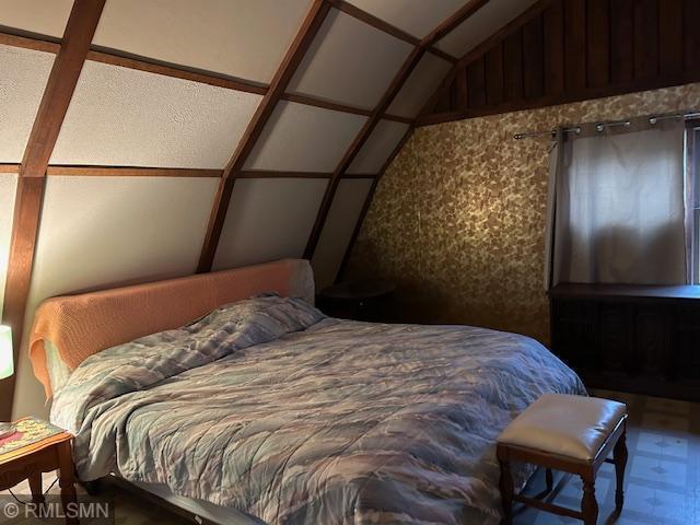 bedroom with lofted ceiling