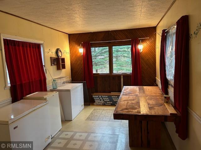 laundry room featuring wooden walls