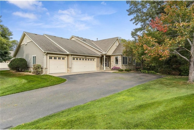 view of front of house with a front lawn and a garage