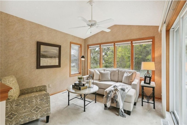 living room featuring lofted ceiling, light carpet, and ceiling fan