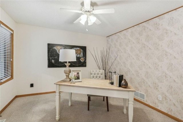 carpeted office with ceiling fan and a textured ceiling