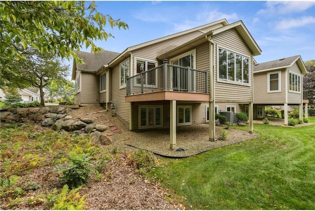 back of house with central AC unit, a lawn, a deck, and a patio area