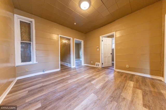 empty room with light hardwood / wood-style flooring