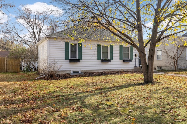 view of side of property with a lawn