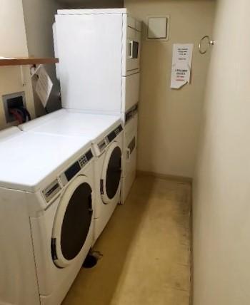 washroom with independent washer and dryer and stacked washer and dryer