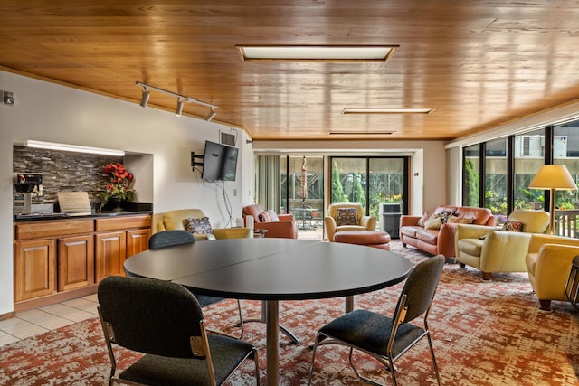 tiled dining room with wooden ceiling and track lighting