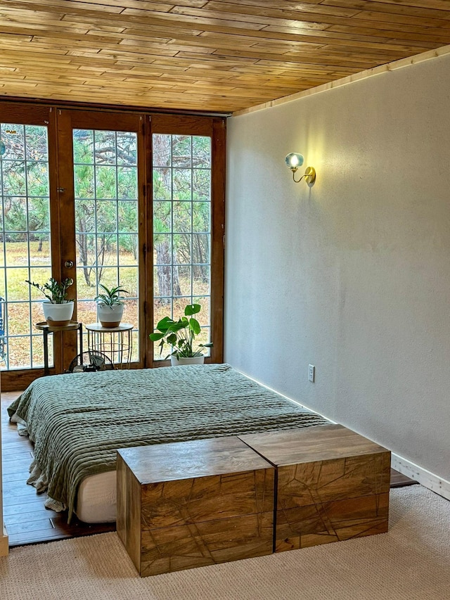 bedroom with french doors, wood ceiling, and carpet flooring