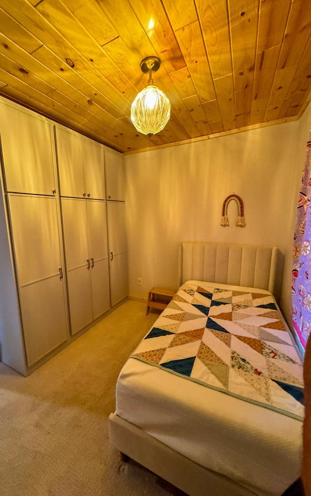 bedroom featuring light colored carpet and wooden ceiling