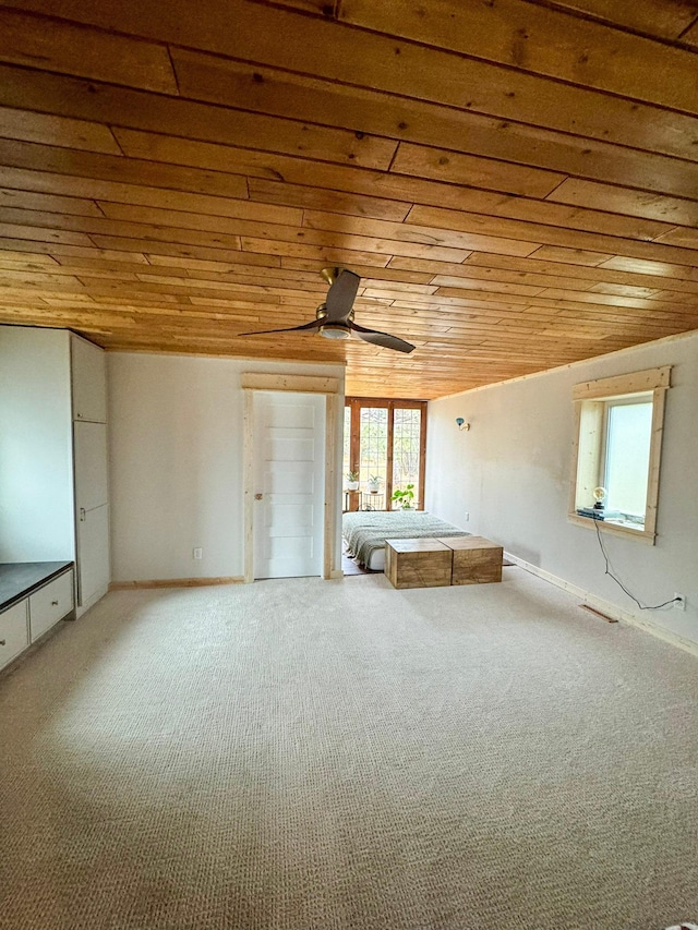 unfurnished bedroom with carpet, wood ceiling, and ceiling fan