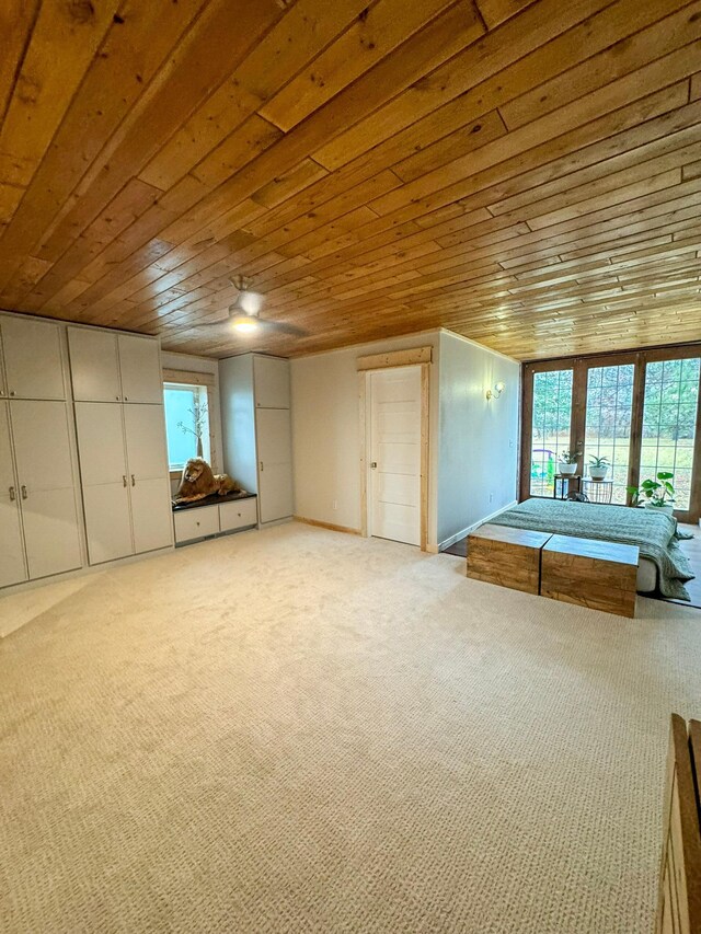 unfurnished bedroom with light carpet, multiple windows, and wooden ceiling