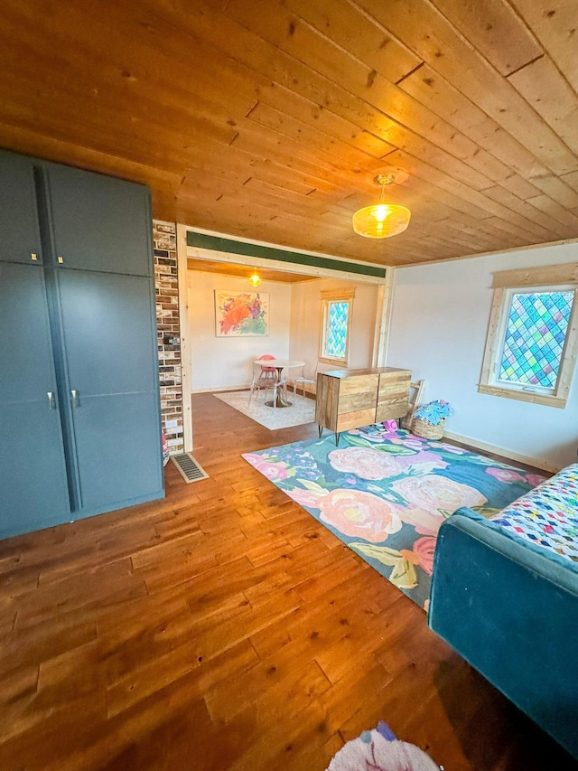 bedroom with wood ceiling and wood-type flooring