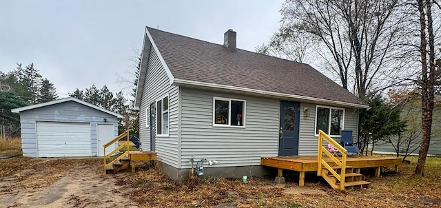 view of front facade with a garage and an outdoor structure