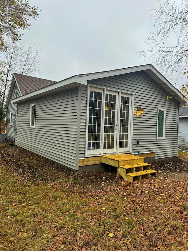 rear view of house with french doors and central AC