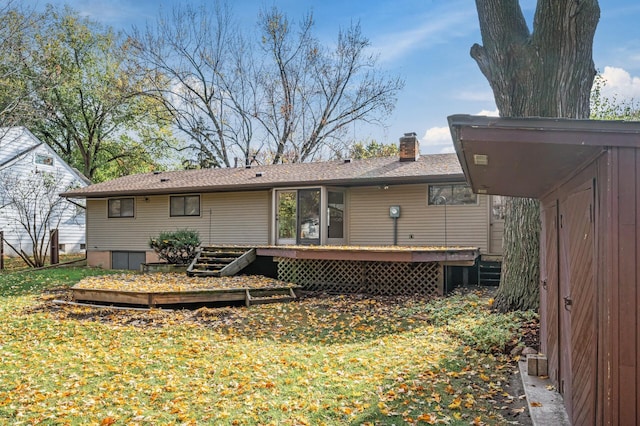 rear view of property with a yard and a deck