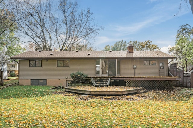 back of house with a wooden deck and a lawn