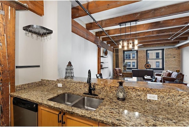 kitchen with brick wall, stainless steel dishwasher, sink, and stone counters