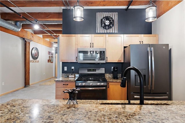 kitchen with appliances with stainless steel finishes, beam ceiling, light brown cabinets, stone counters, and hanging light fixtures