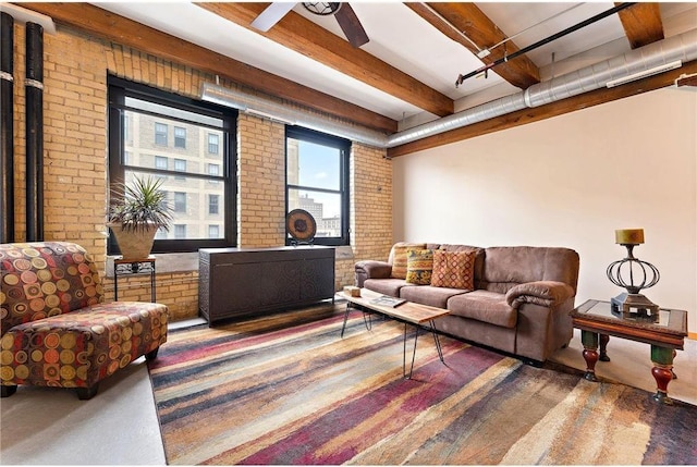 living room featuring brick wall, ceiling fan, and beam ceiling