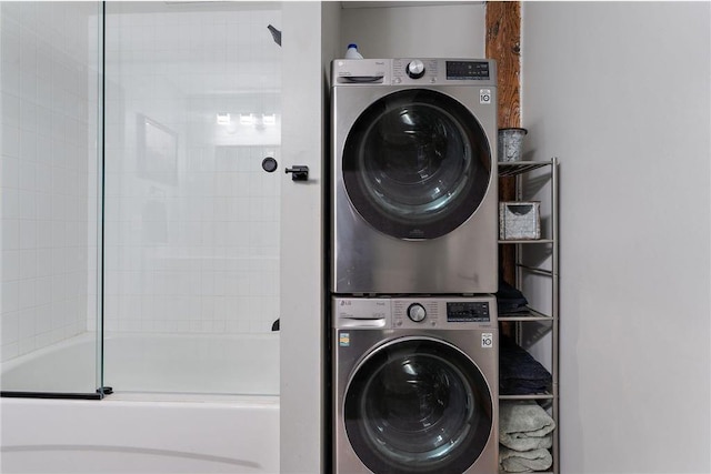 clothes washing area with stacked washing maching and dryer