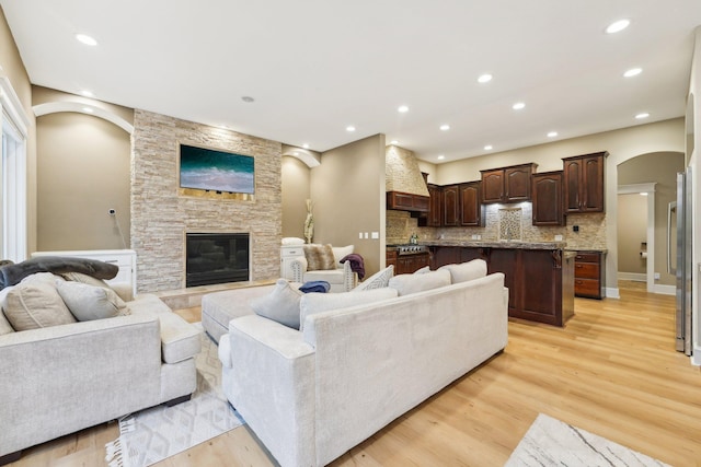 living room with a fireplace and light hardwood / wood-style floors