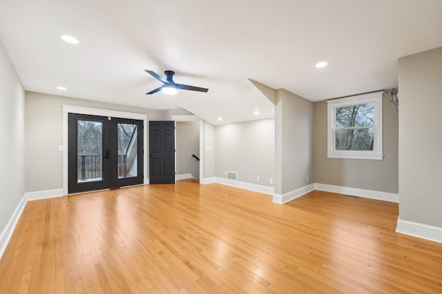 unfurnished living room with french doors, ceiling fan, and light hardwood / wood-style flooring