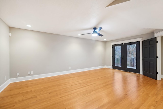 empty room with light wood-type flooring, french doors, and ceiling fan