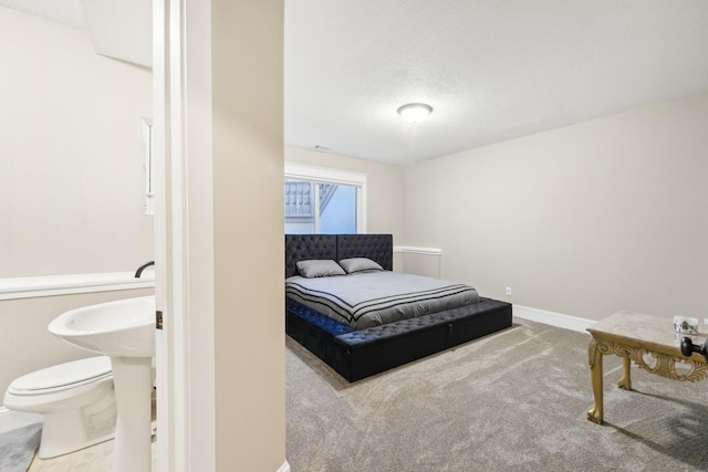 carpeted bedroom featuring a textured ceiling