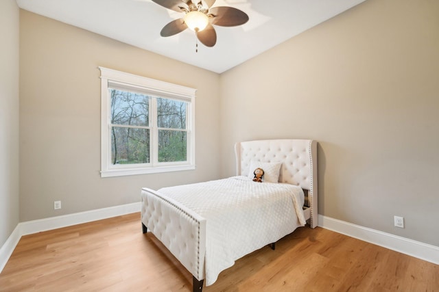 bedroom with light hardwood / wood-style floors and ceiling fan